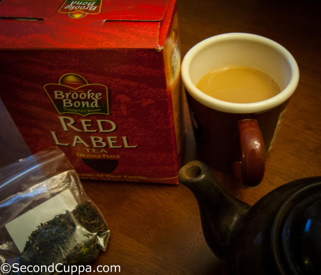 Image of Brooke Bond Red Label Tea package with teapot, mug and loose Darjeeling tea