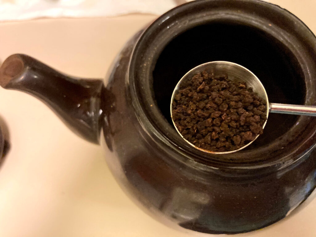 Placing tea in a Brown Betty teapot
