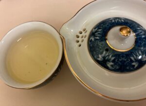 Gaiwan next to a tea cup filled with Teavivre Chun Ya green tea
